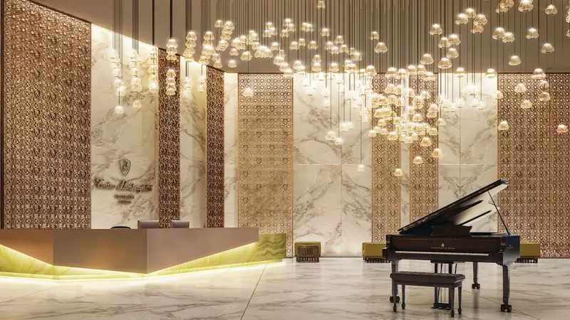 Tonino Lamborghini Residences - Grand arrival lobby with cascading chandelier and grand piano